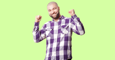 Smiling Latino man with a checkered purple button up shirt and a lime green background